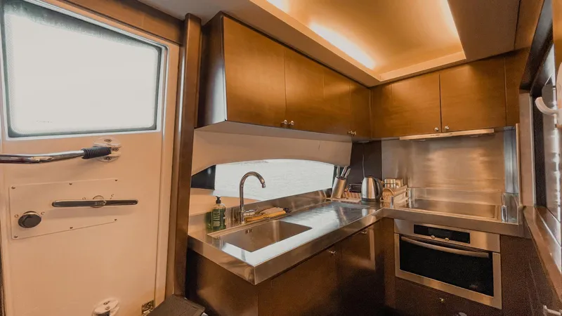  Yacht Photos Pics Luxurious kitchen interior of 2009 Azimut 75 yacht with modern appliances and sleek design.