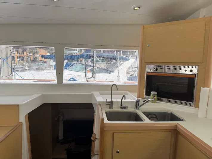 Feel The Moon Yacht Photos Pics Interior of 2010 Lagoon 400 yacht kitchen with dual sinks and window view.