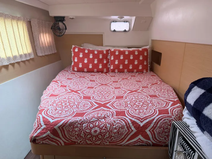 Feel The Moon Yacht Photos Pics Cozy bedroom in 2010 Lagoon 400 yacht with red patterned bedding and nautical decor.