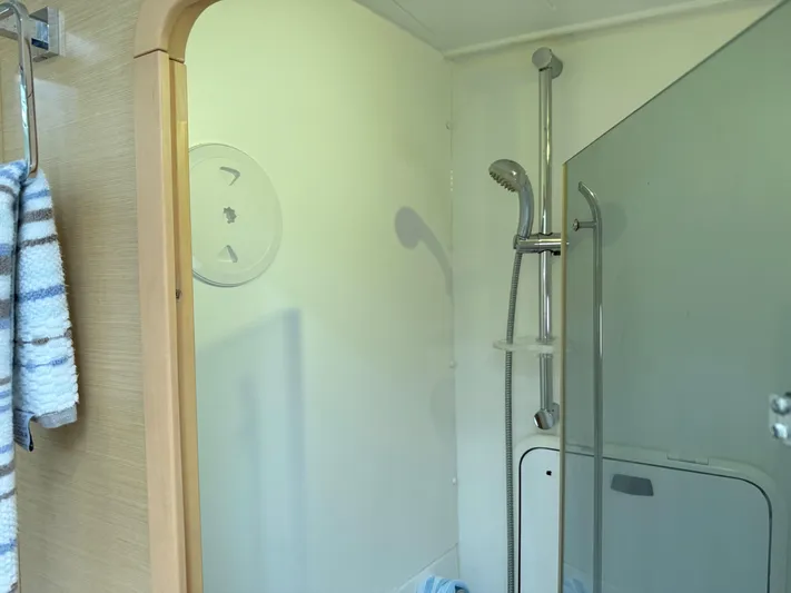 Feel The Moon Yacht Photos Pics Shower area in 2010 Lagoon 400 Owner's Version yacht, featuring modern fixtures and glass partition.