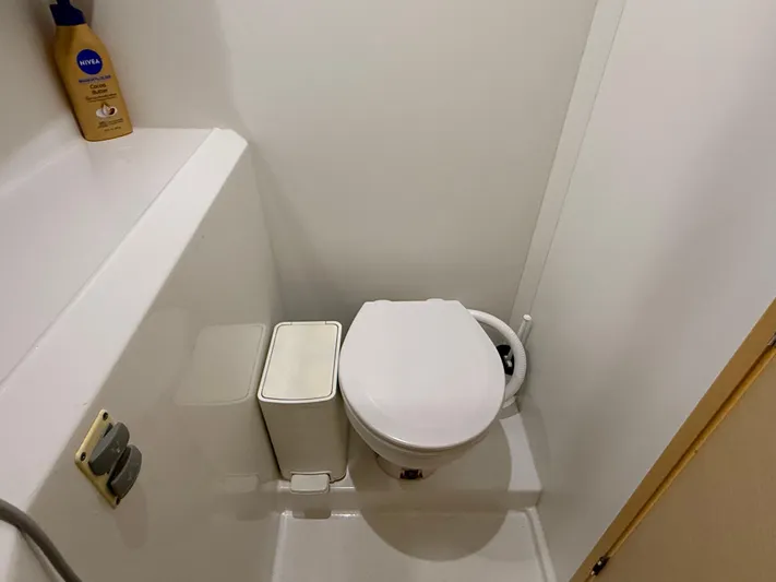 Feel The Moon Yacht Photos Pics Compact bathroom in 2010 Lagoon 400 yacht, featuring a toilet and storage space.