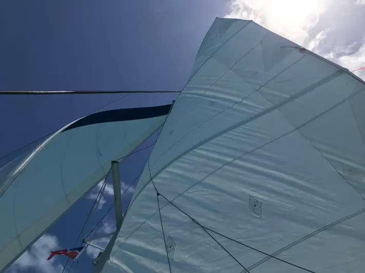 Feel The Moon Yacht Photos Pics Sails of a 2010 Lagoon 400 catamaran against a clear blue sky.