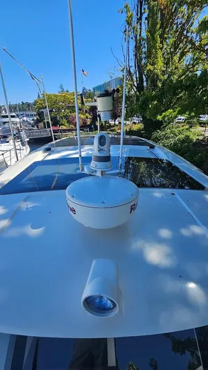 Bryanne Yacht Photos Pics 2014 Greenline 40 yacht with radar and camera on deck, docked near trees and buildings.