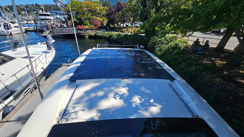 Bryanne Yacht Photos Pics 2014 Greenline 40 yacht with solar panels docked near lush greenery and other boats.