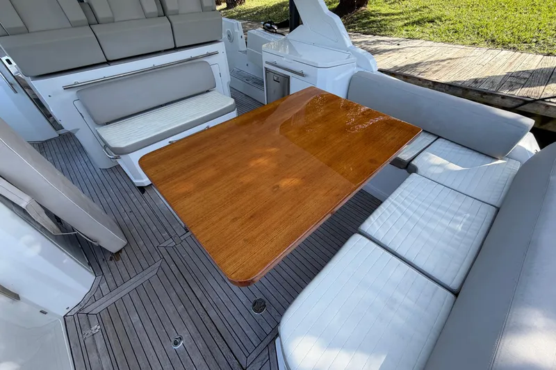 Veloce Yacht Photos Pics 2017 Azimut Verve 40 yacht interior with wooden table and cushioned seating.