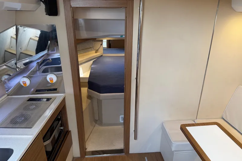 Veloce Yacht Photos Pics Interior of 2017 Azimut Verve 40 yacht, featuring kitchen and cozy sleeping area.