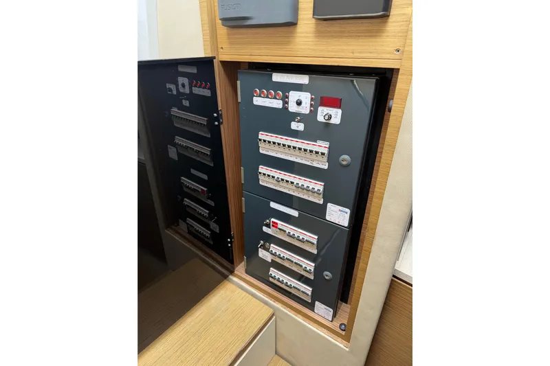 Veloce Yacht Photos Pics Electrical panel inside 2017 Azimut Verve 40 yacht, showcasing circuit breakers and controls.