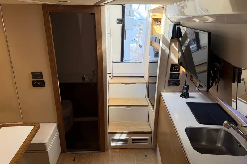Veloce Yacht Photos Pics Interior of 2017 Azimut Verve 40 yacht with modern kitchen and wooden accents.