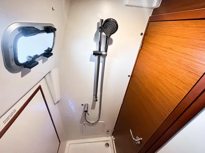 Soca Sleigh Yacht Photos Pics 2024 Jeanneau Sun Odyssey 380 shower area with modern fixtures and wooden accents.