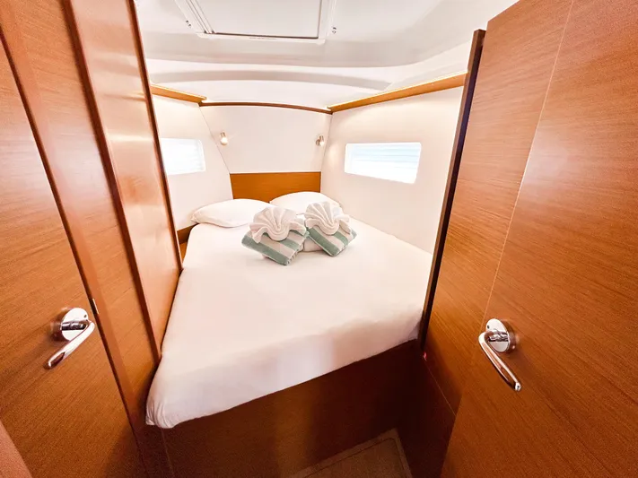 Soca Sleigh Yacht Photos Pics 2024 Jeanneau Sun Odyssey 380 cabin with cozy bed and elegant wood finish.