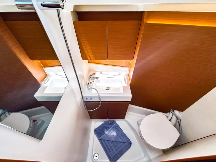 Soca Sleigh Yacht Photos Pics 2024 Jeanneau Sun Odyssey 380 bathroom with modern fixtures and wooden cabinetry.