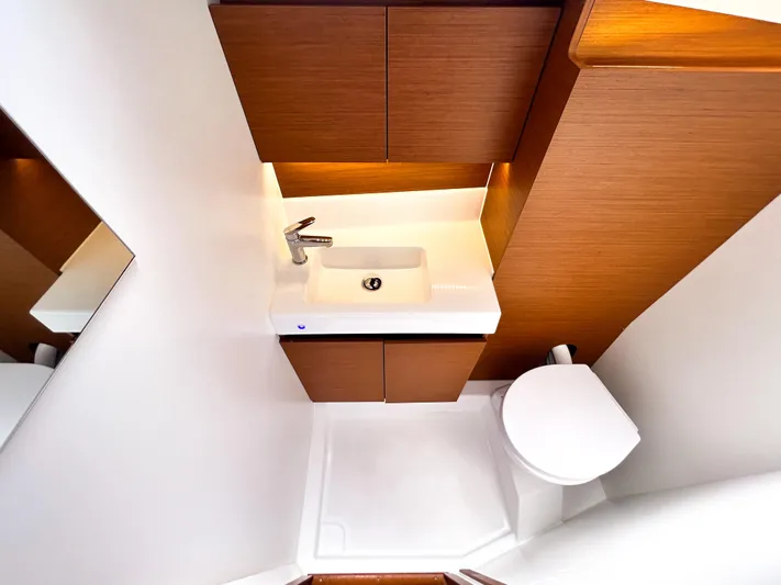 Soca Sleigh Yacht Photos Pics 2024 Jeanneau Sun Odyssey 380 bathroom with modern sink and toilet, sleek wood cabinetry.