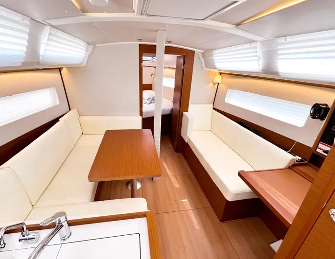 Soca Sleigh Yacht Photos Pics 2024 Jeanneau Sun Odyssey 380 interior with modern seating and wooden finishes.