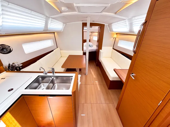 Soca Sleigh Yacht Photos Pics 2024 Jeanneau Sun Odyssey 380 interior with modern kitchen, seating, and wood finishes.