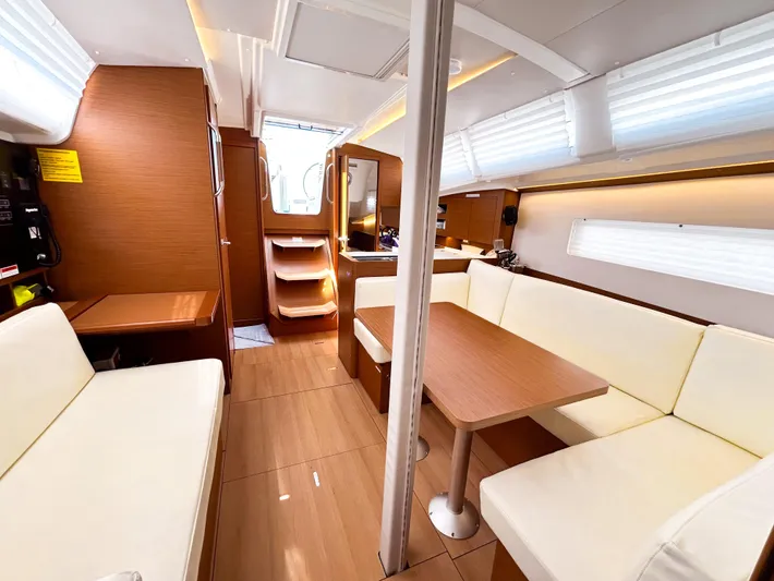 Soca Sleigh Yacht Photos Pics Interior of 2024 Jeanneau Sun Odyssey 380 yacht with modern seating and wooden finishes.