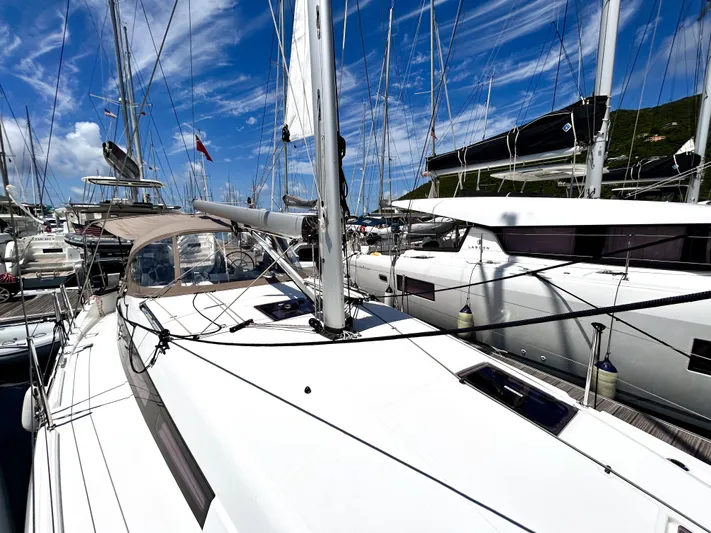 Soca Sleigh Yacht Photos Pics 2024 Jeanneau Sun Odyssey 380 sailboat docked in a marina under a clear blue sky.