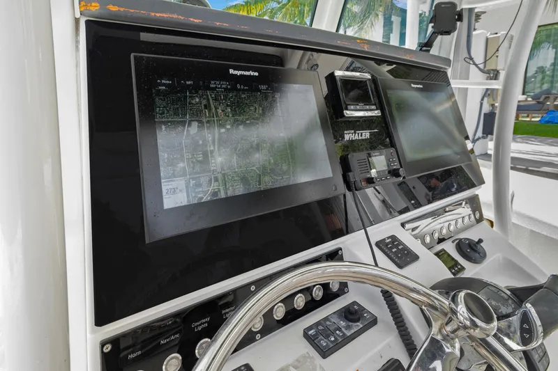  Yacht Photos Pics Dashboard of a 2014 Boston Whaler 320 Outrage with navigation screens and controls.