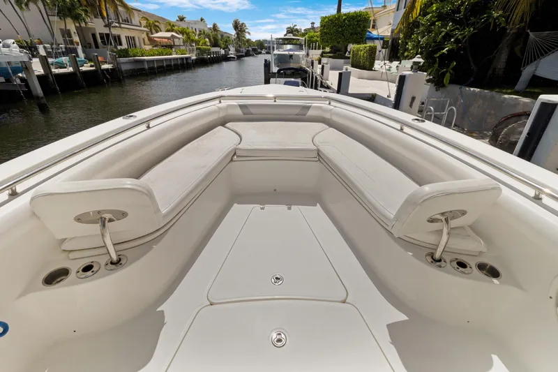  Yacht Photos Pics 2014 Boston Whaler 320 Outrage boat interior with cushioned seating and canal view.