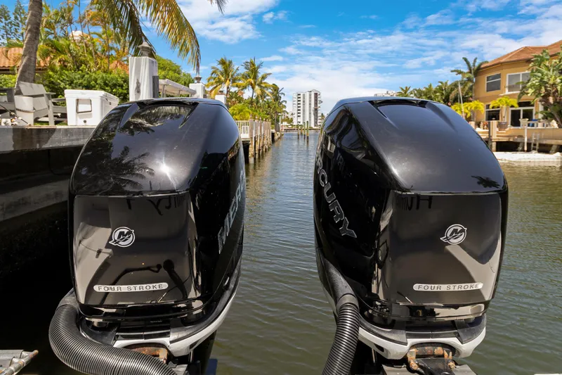  Yacht Photos Pics Twin Mercury outboard engines on a 2014 Boston Whaler 320 Outrage, docked in a scenic canal.