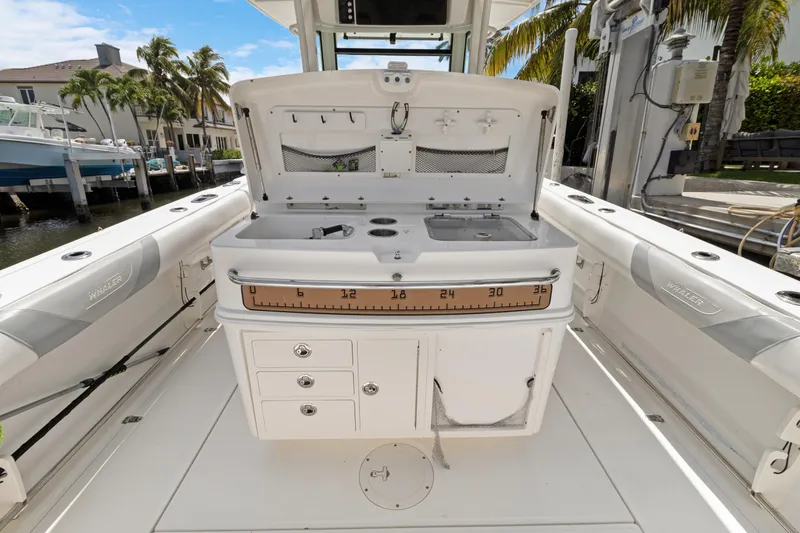  Yacht Photos Pics 2014 Boston Whaler 320 Outrage boat interior with fishing station and storage compartments.