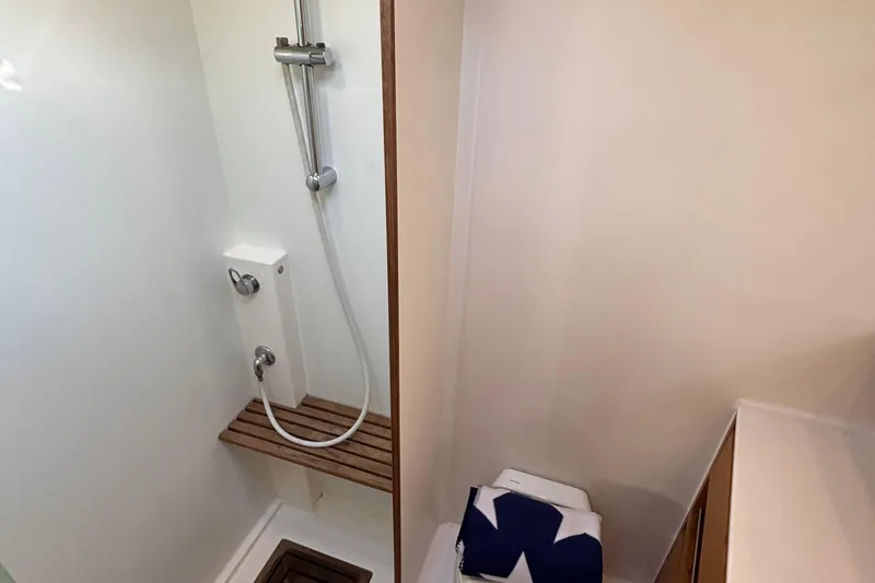 Abide Yacht Photos Pics Shower area in 2018 X-Yachts X4.9, featuring wooden bench and modern fixtures.