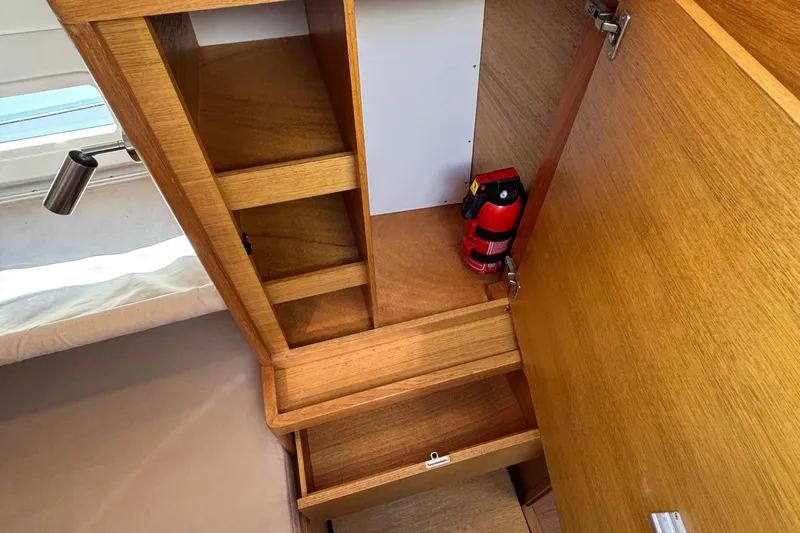 Abide Yacht Photos Pics 2018 X-Yachts X4.9 interior storage with fire extinguisher and wooden shelves.