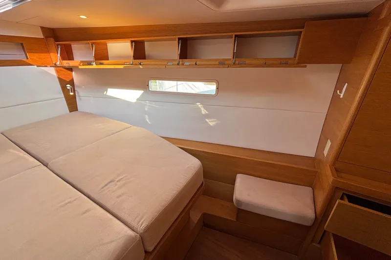 Abide Yacht Photos Pics Luxurious interior of 2018 X-Yachts X4.9 with wooden cabinetry and comfortable bedding.