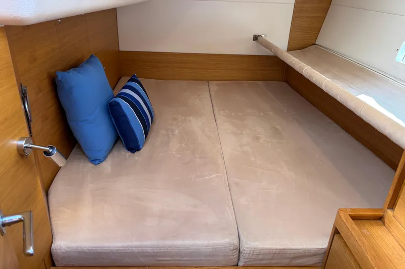 Abide Yacht Photos Pics Cozy cabin interior of 2018 X-Yachts X4.9 with blue and striped pillows.