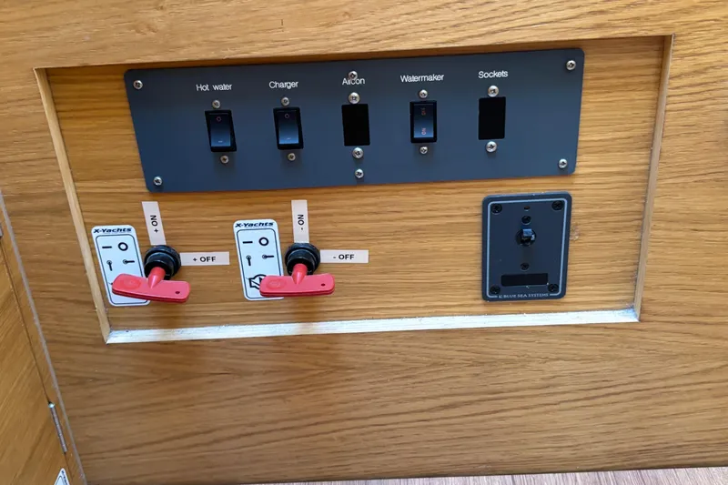 Abide Yacht Photos Pics Control panel of a 2018 X-Yachts X4.9, featuring switches for hot water, charger, and more.