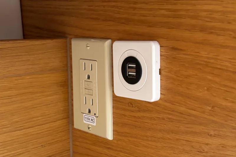 Abide Yacht Photos Pics Power outlet and USB charger on X-Yachts X4.9, 2018 model, wooden interior.