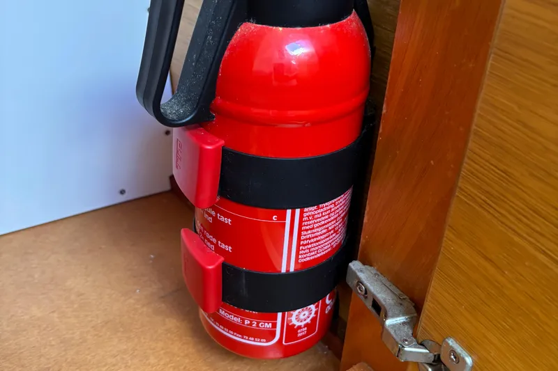 Abide Yacht Photos Pics Red fire extinguisher mounted inside X-Yachts X4.9, 2018 model, wooden interior.