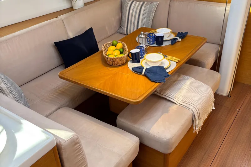 Abide Yacht Photos Pics Cozy dining area in 2018 X-Yachts X4.9 with wooden table and cushioned seating.