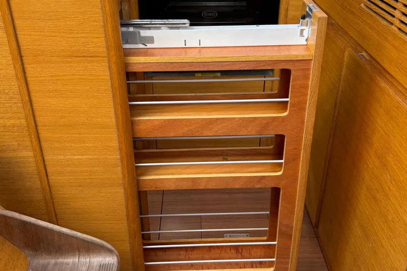 Abide Yacht Photos Pics Wooden interior shelving in 2018 X-Yachts X4.9 sailboat, featuring sleek metal accents.