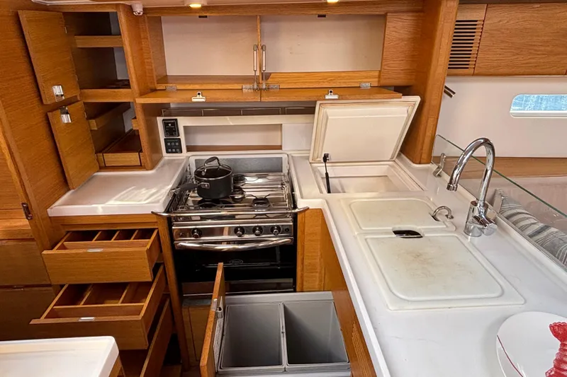 Abide Yacht Photos Pics Luxurious 2018 X-Yachts X4.9 yacht kitchen with modern appliances and wooden cabinetry.