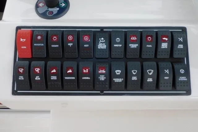  Yacht Photos Pics Control panel of a 2019 Pursuit OS 325 Offshore boat with labeled switches.