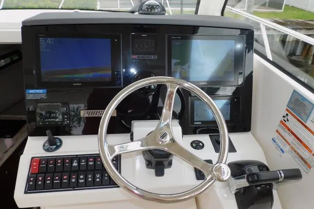  Yacht Photos Pics 2019 Pursuit OS 325 Offshore helm with modern navigation displays and controls.
