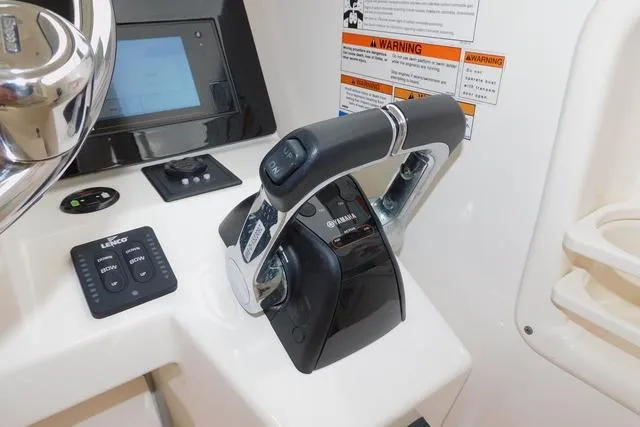  Yacht Photos Pics 2019 Pursuit OS 325 Offshore boat control panel with throttle and navigation display.