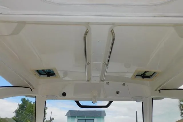  Yacht Photos Pics 2019 Pursuit OS 325 Offshore boat interior ceiling with hatches and grab rails.