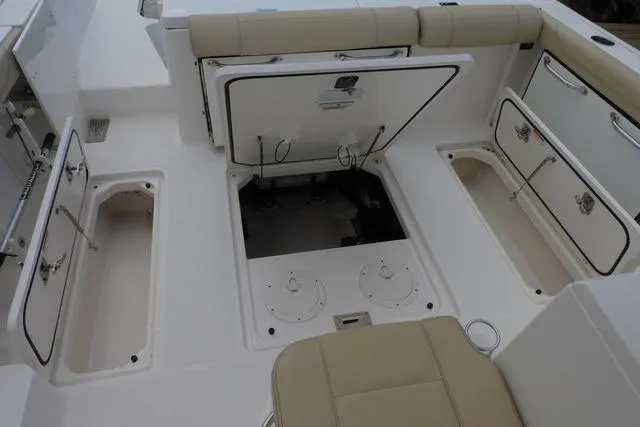  Yacht Photos Pics 2019 Pursuit OS 325 Offshore boat interior with open storage compartments and seating.
