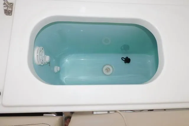  Yacht Photos Pics Livewell tank on a 2019 Pursuit OS 325 Offshore boat, filled with water.