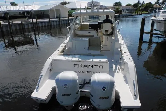  Yacht Photos Pics 2019 Pursuit OS 325 Offshore boat docked, featuring twin engines and spacious deck.