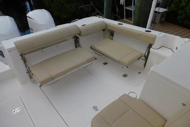  Yacht Photos Pics 2019 Pursuit OS 325 Offshore boat with beige foldable seating in the cockpit area.