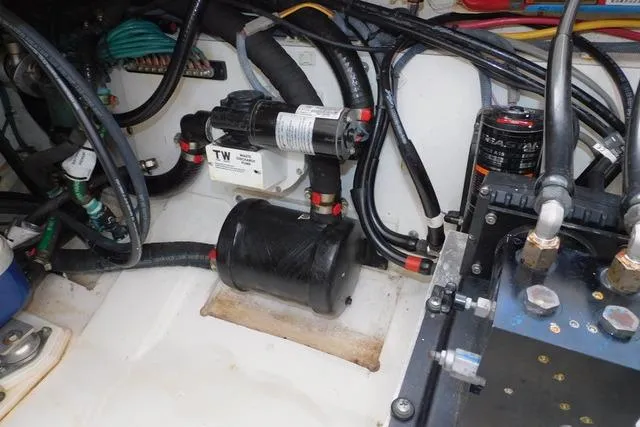  Yacht Photos Pics Engine compartment of a 2019 Pursuit OS 325 Offshore boat, showcasing wiring and components.