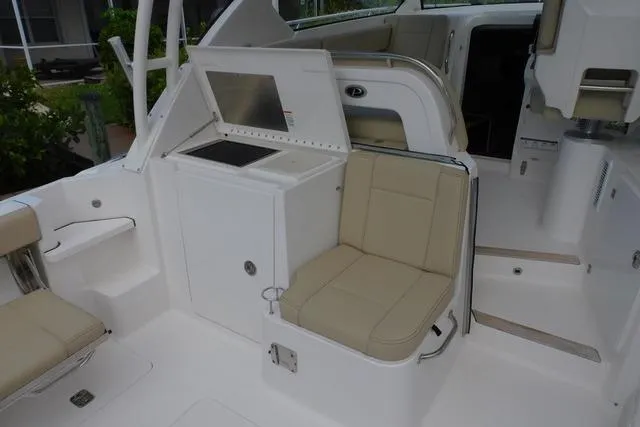  Yacht Photos Pics 2019 Pursuit OS 325 Offshore boat interior with beige seating and white cabinetry.