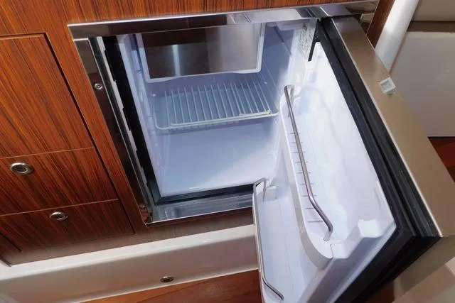 Yacht Photos Pics Open refrigerator in 2019 Pursuit OS 325 Offshore boat interior.