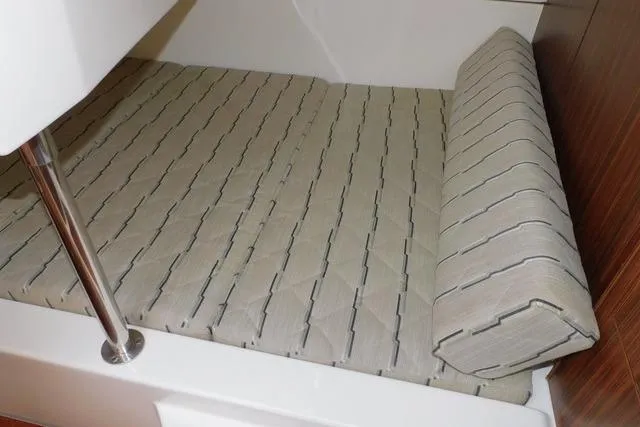  Yacht Photos Pics 2019 Pursuit OS 325 Offshore cabin interior with cushioned seating and sleek design.