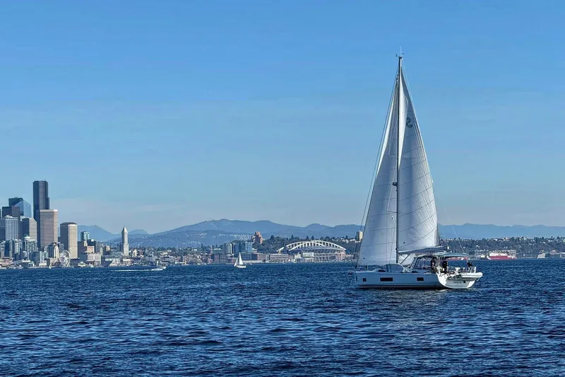 Run For The Roses Yacht Photos Pics Beneteau Oceanis 46.1 sailing near city skyline, clear blue sky, 2019 model.