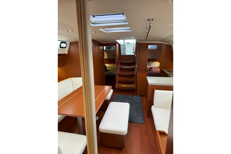 Run For The Roses Yacht Photos Pics Interior of 2019 Beneteau Oceanis 46.1 yacht with wood finish and white seating.