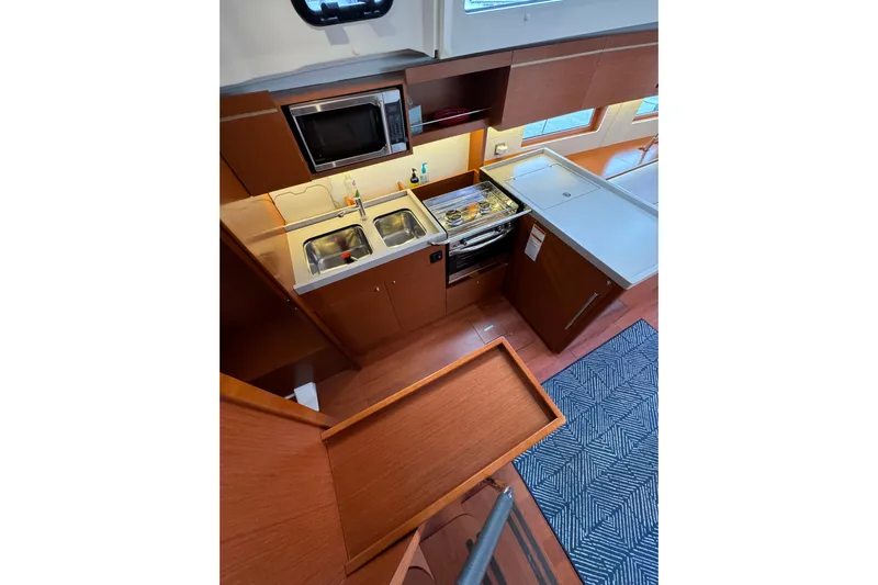 Run For The Roses Yacht Photos Pics 2019 Beneteau Oceanis 46.1 yacht kitchen with modern appliances and wooden cabinetry.