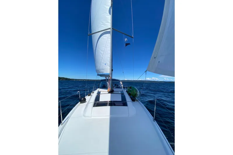 Run For The Roses Yacht Photos Pics 2019 Beneteau Oceanis 46.1 sailing on open sea under clear blue sky.